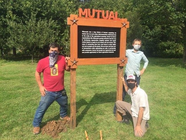 Jay Salinas of Wormfarm Institute, Kase Wheatley of Grassland 2.0, and Paul Huber of Rooted installing a field note along the DTour route.